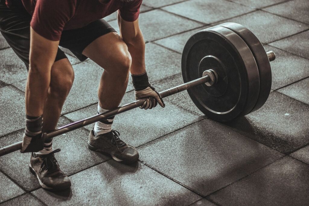 A man lifting a loaded barbell